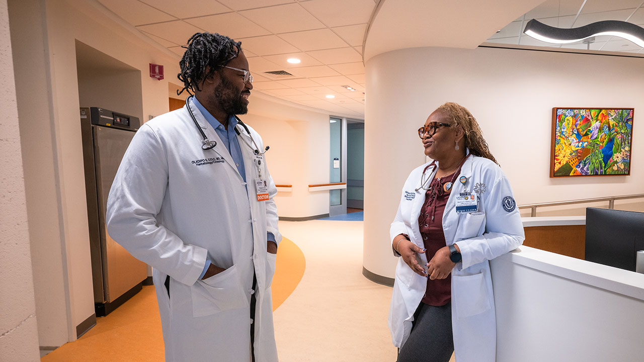 Dr. Oladipo Cole talking to Genice Nelson, a nurse in the hospital
