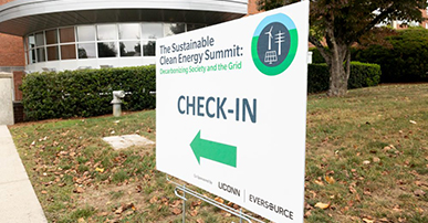 A sign for the Sustainable Clean Energy Summit sits outside the Student Union