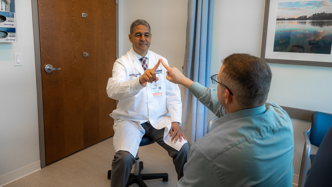 Dr. Bernardo Rodrigues with a patient testing for Huntington's disease
