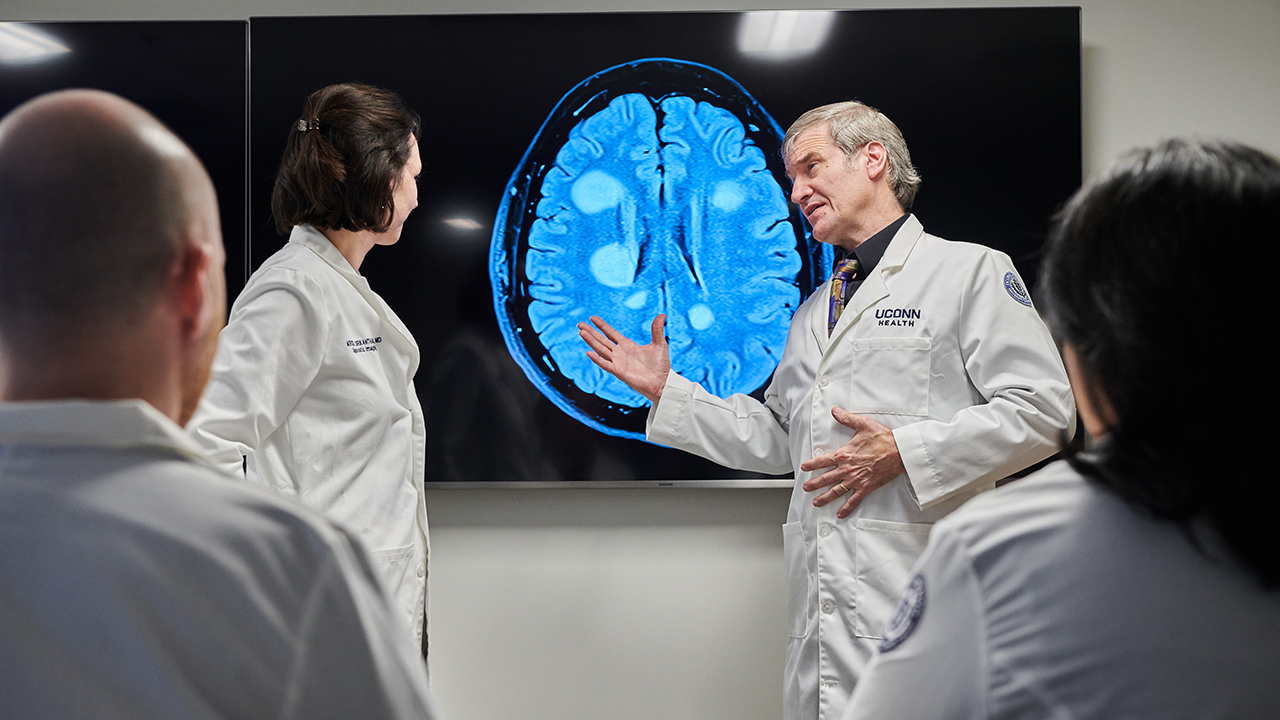 Leo Wolansky, MD, reviews an MRI of a brain from a patient who has multiple sclerosis