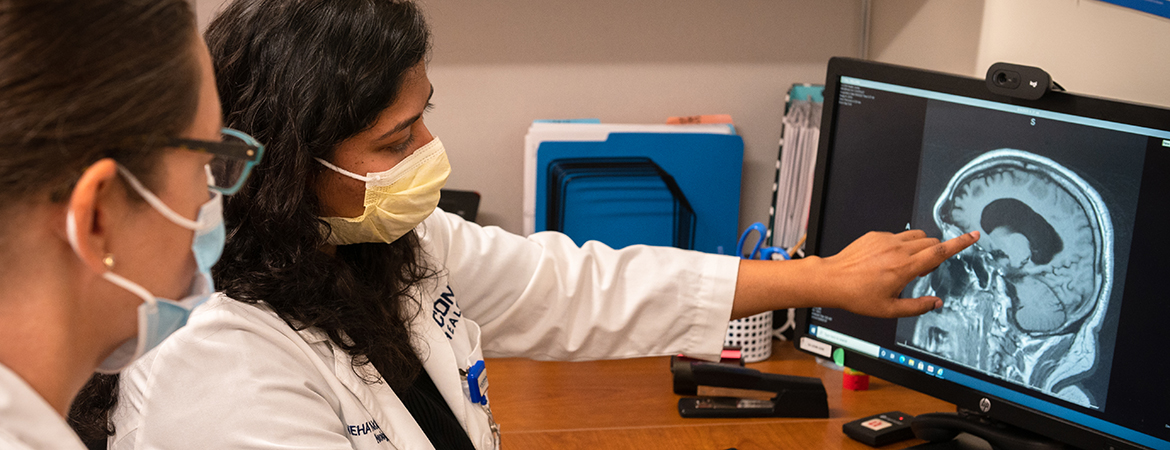 Neurologist Neha Prakash, M.B.B.S, reviews a radiological scan with a nurse practitioner