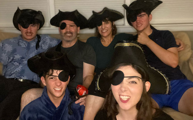 Scott Flanagan and his family sport eye patches sitting on a couch