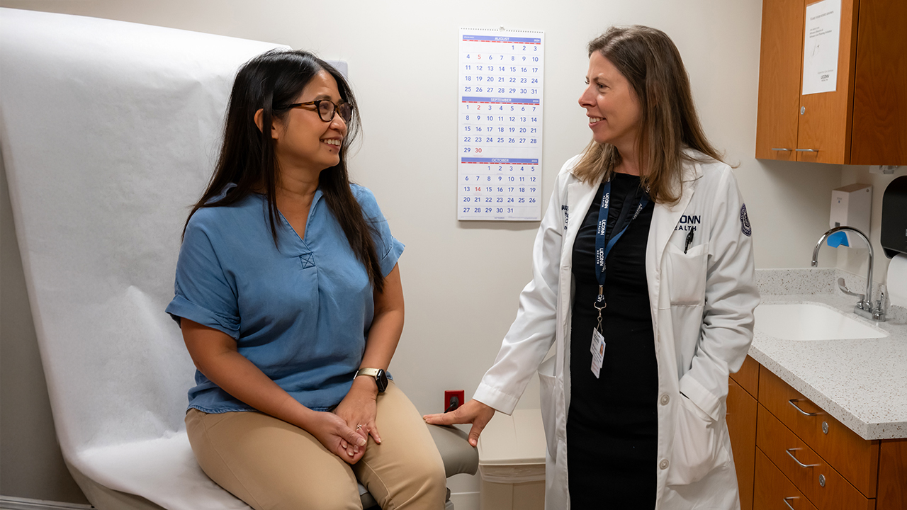 Dr. Margaret Callahan talking to a patient in an exam room