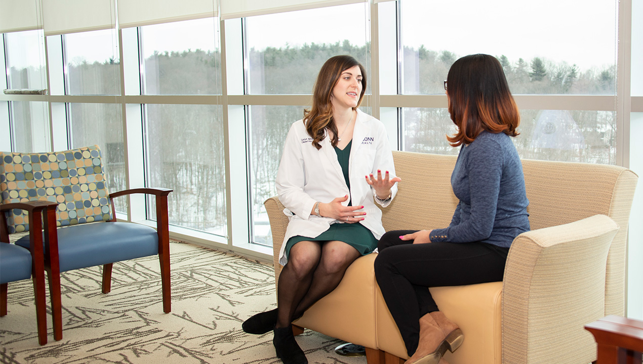 Dr. Dana Scott talks to a patient in the waiting room