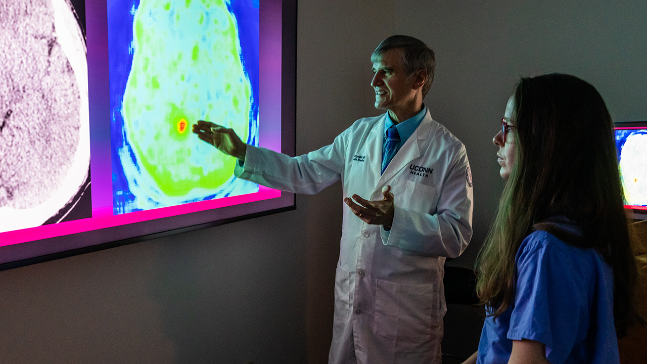 Chair of radiology Leo Wolansky, MD, and resident Sarah LaPierre, MD, review brain scans