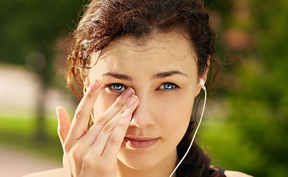 Runner rubbing her eyes