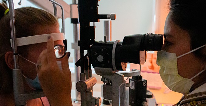 Dr. Falcone performing an eye exam