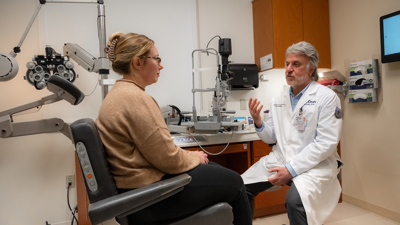 Dry-eye specialist Edmund Farris, MD, meets with a patient in an exam room
