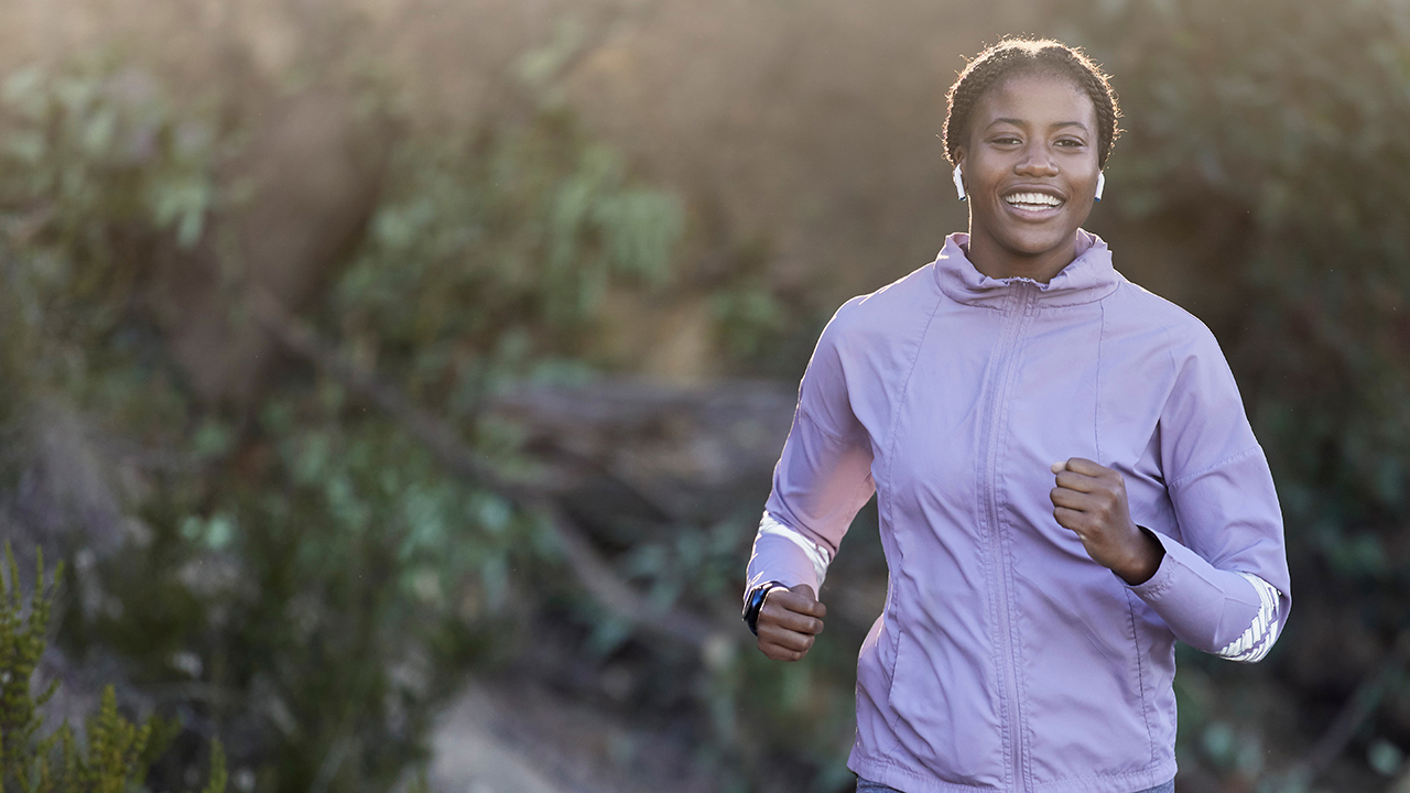 African American woman jogging outside