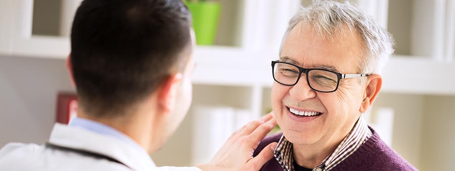 Smiling senior male patient visiting a doctor