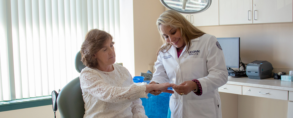 Doctor checking skin on hand