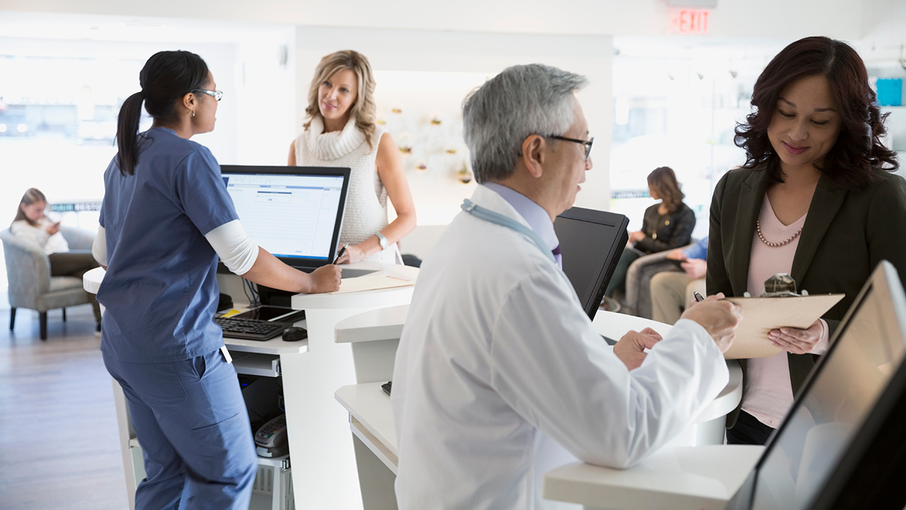Patients checking in at a plastic surgery reception desk