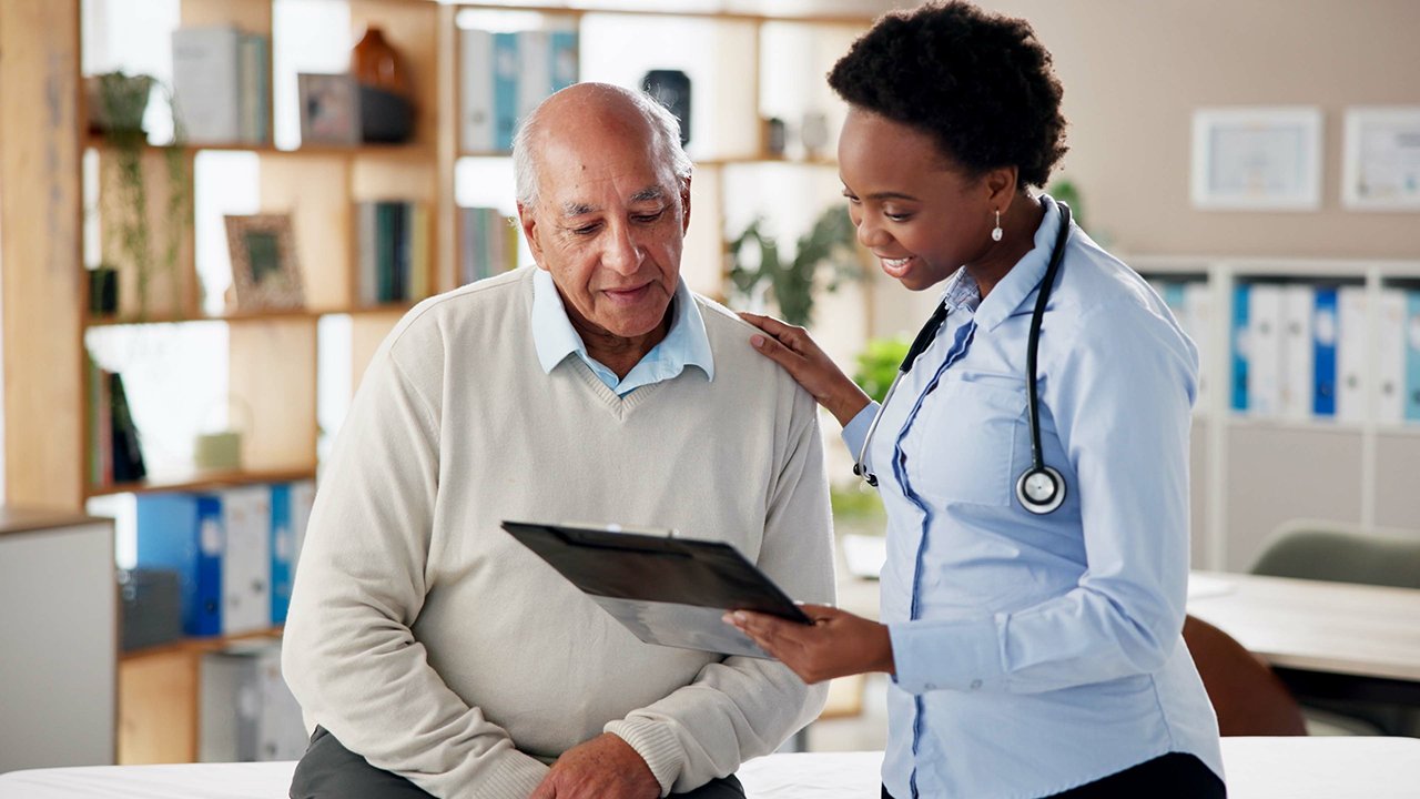 A senior patient meeting with a provider going over instructions